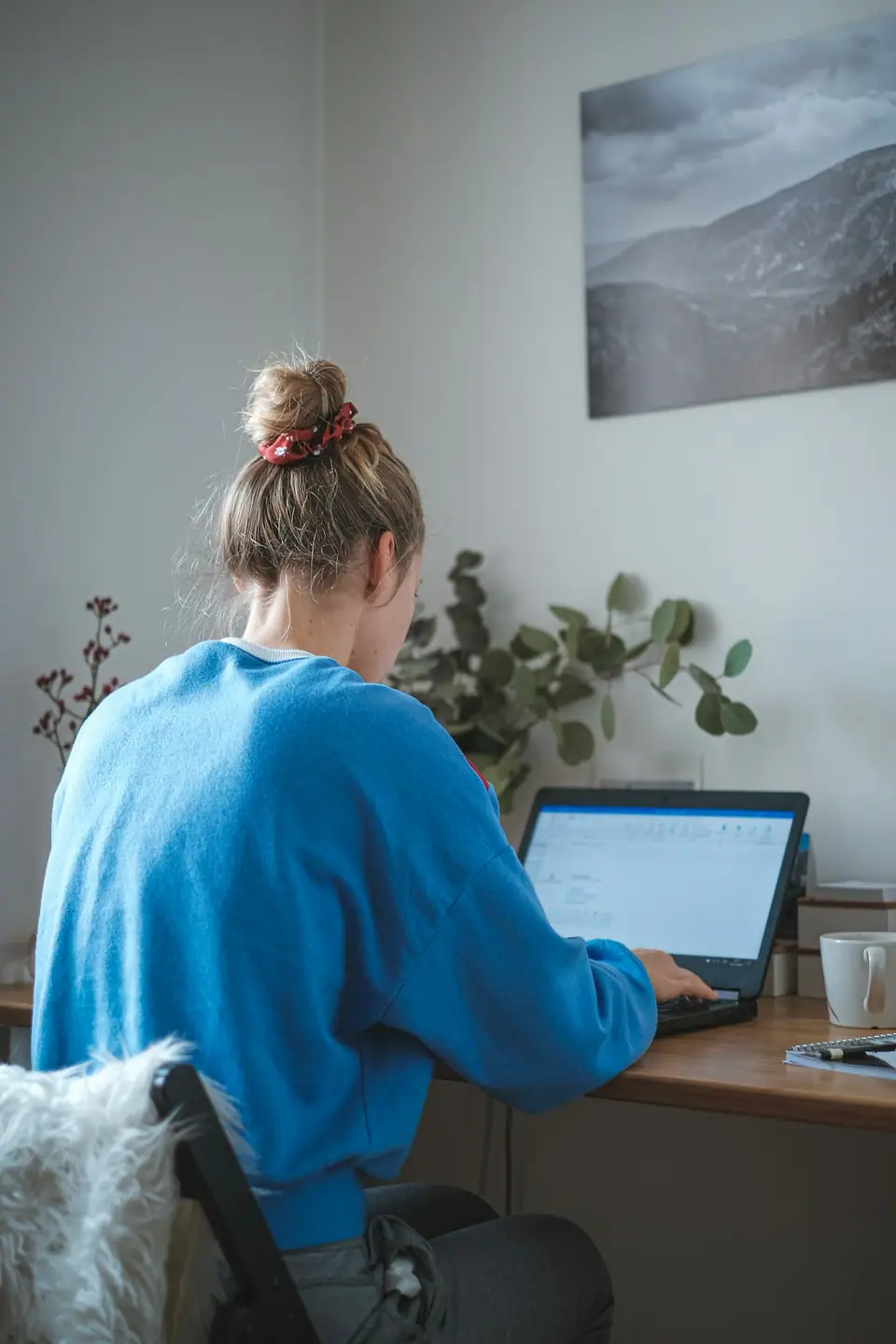 Sample profile photo: a social media assistant at her laptop
