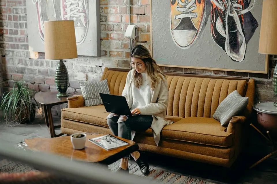 Sample profile photo: a medical receptionist at her laptop