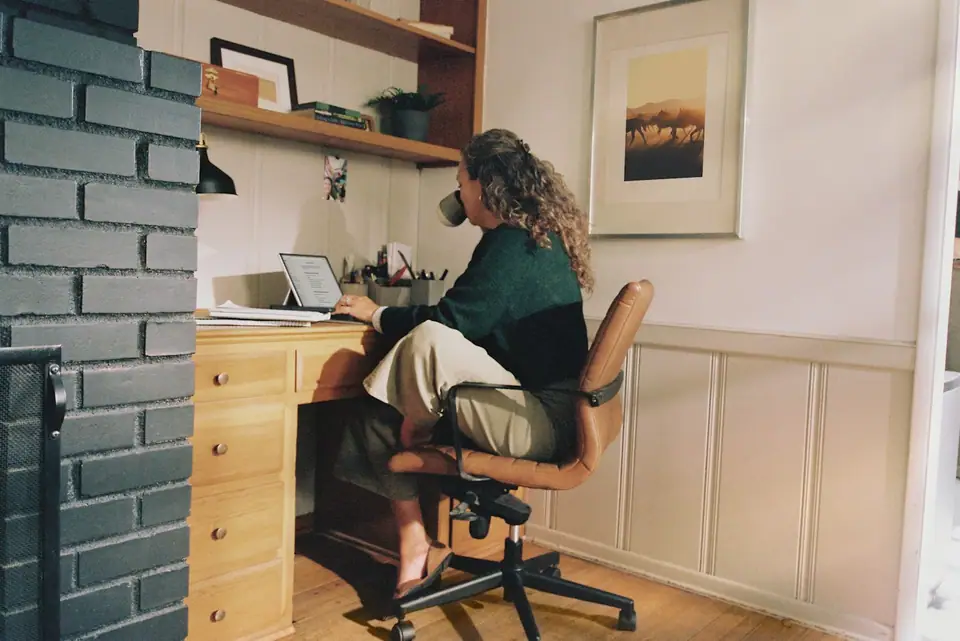 A woman at a desk with a coffee
