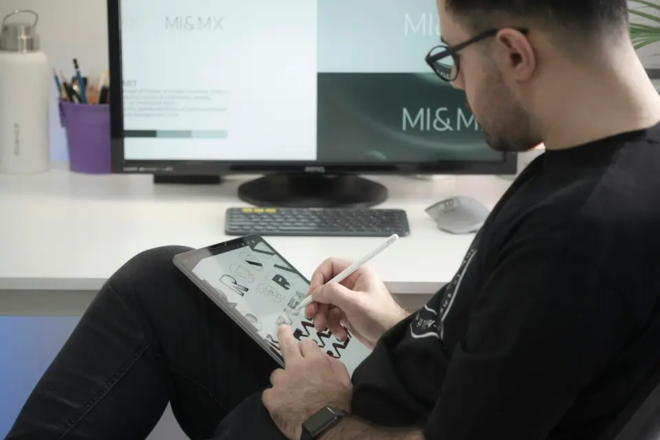 Sample profile photo: a designer sketching on a tablet