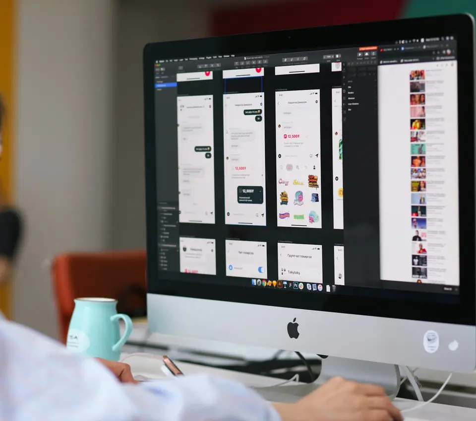 A desk with a large monitor
