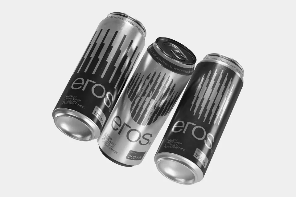 Three silver energy drink cans tumbling on a pale grey ground.