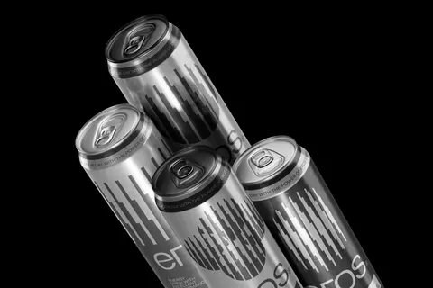 Silver Eros cans clustered against black.