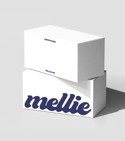 Two stacked white Mellie boxes with the navy script wordmark.
