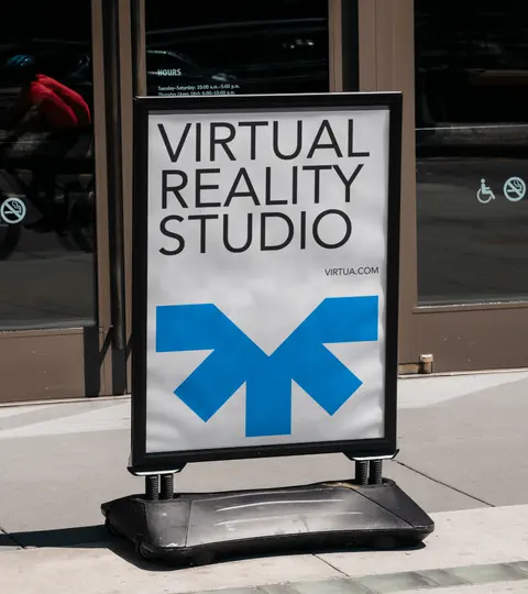A Virtua A-frame sign on a pavement reading Virtual reality studio.