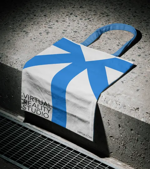 A white and blue tote bag on a concrete step.